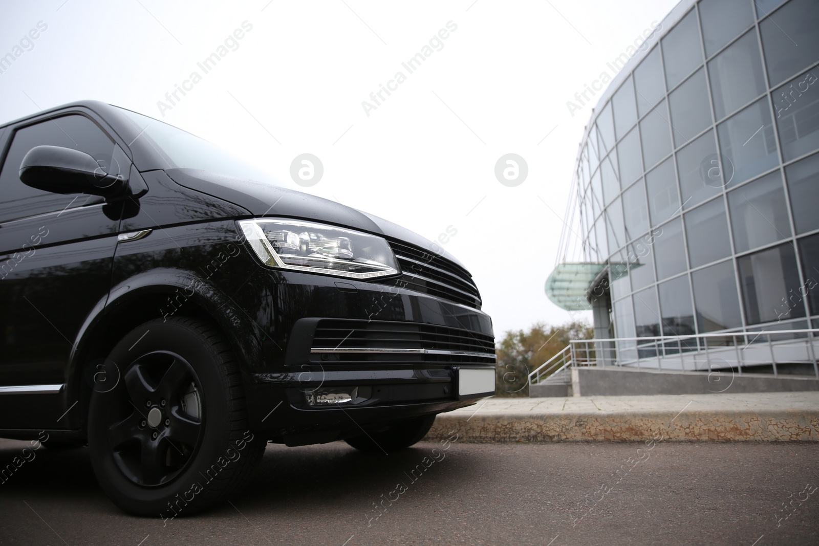 Photo of Black delivery van parked on street near building