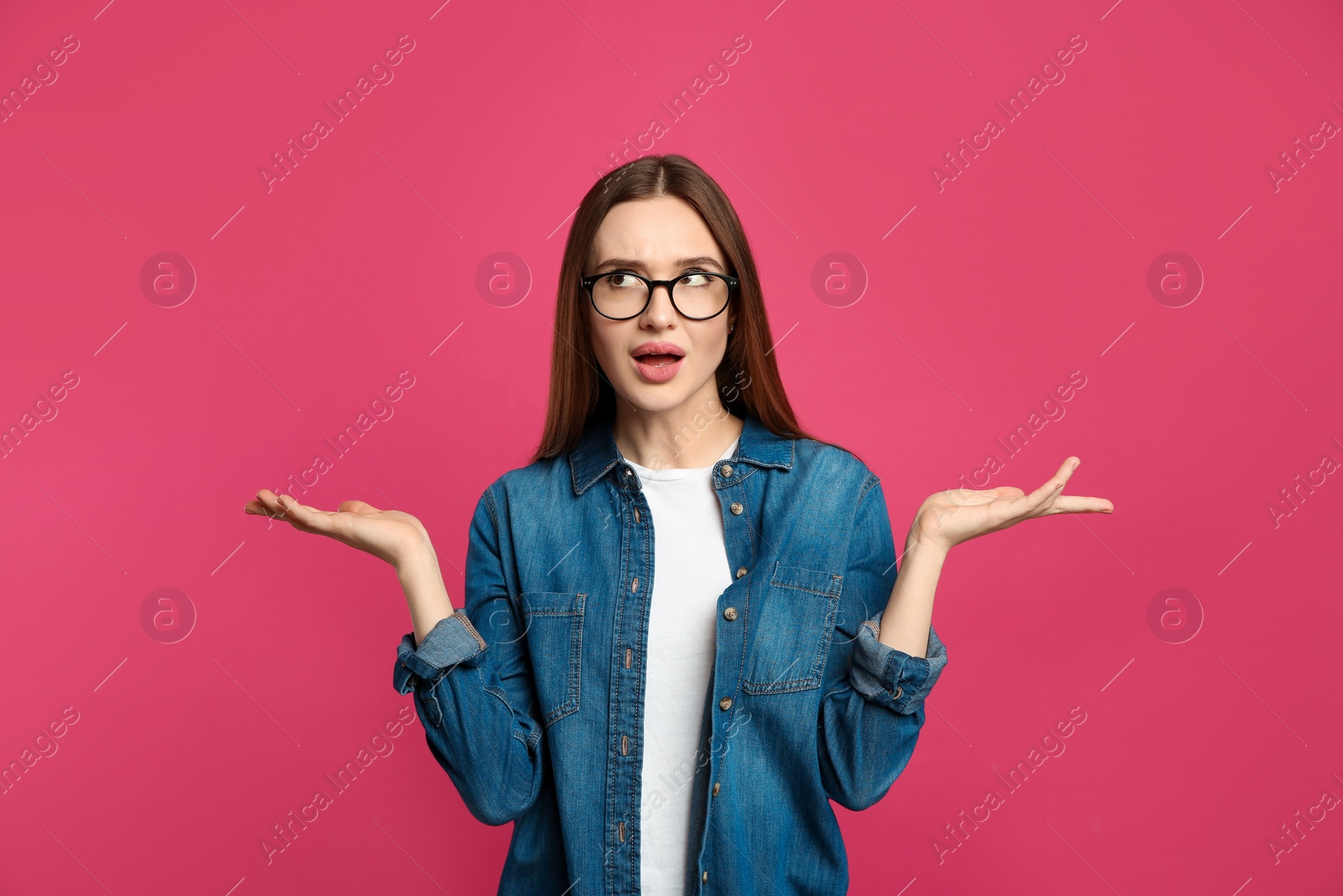 Photo of Pensive woman on pink background. Thinking about answer for question