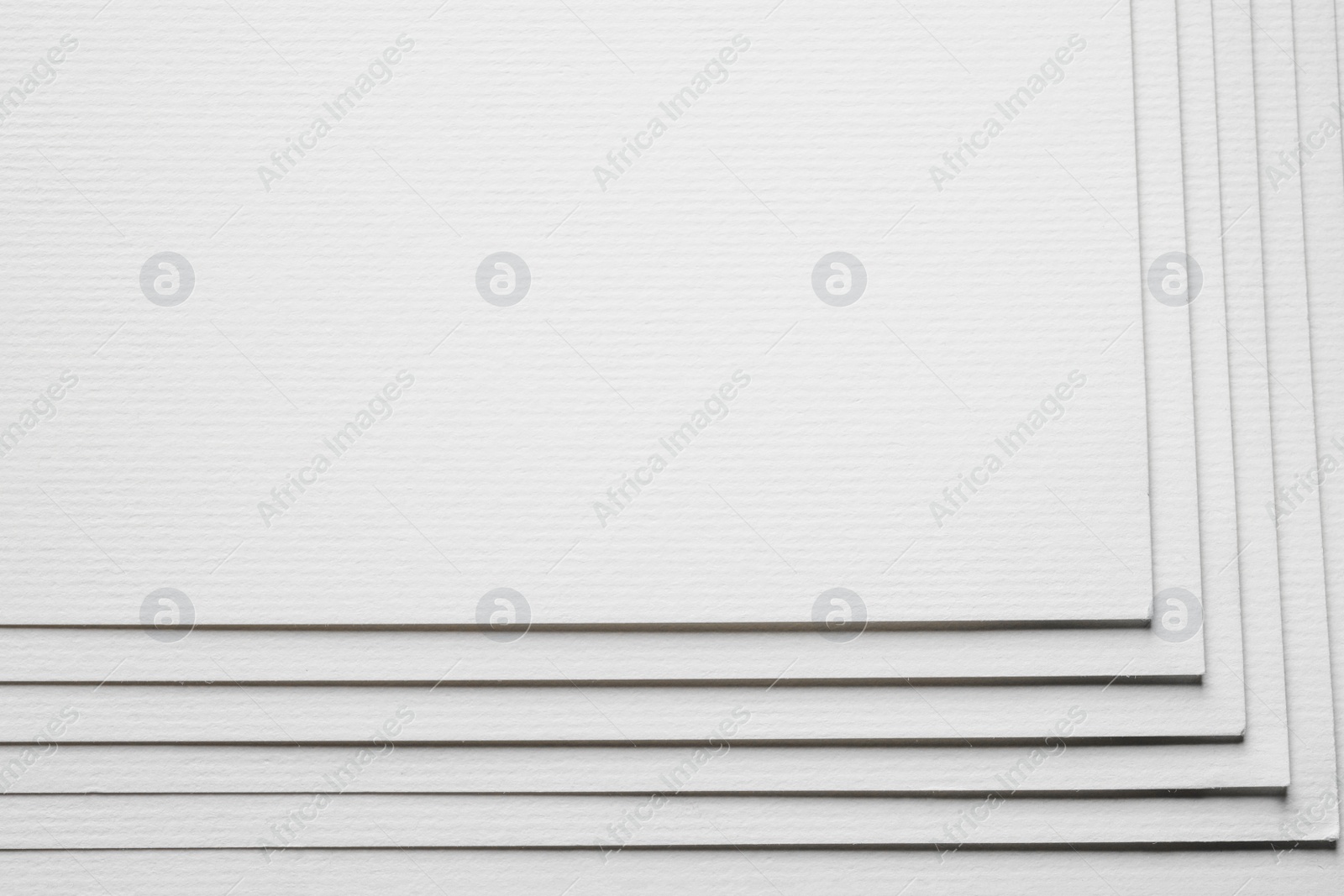 Photo of Stack of white paper sheets as background, closeup