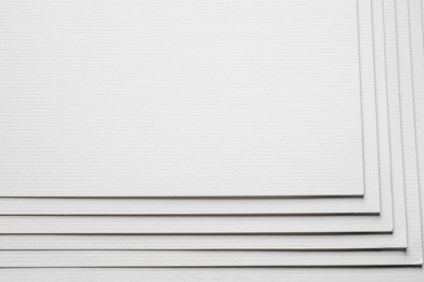 Stack of white paper sheets as background, closeup