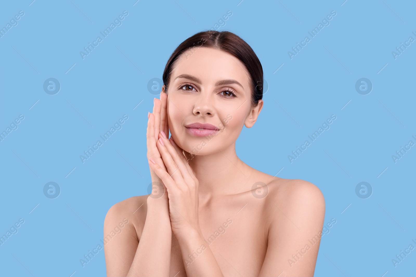 Photo of Beautiful woman with healthy skin on light blue background. Body Care