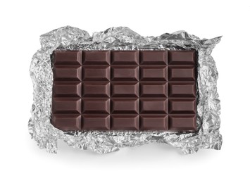 Photo of Delicious dark chocolate bar with foil isolated on white, top view