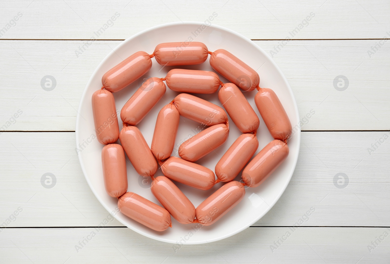 Photo of Delicious sausages on white wooden table, top view