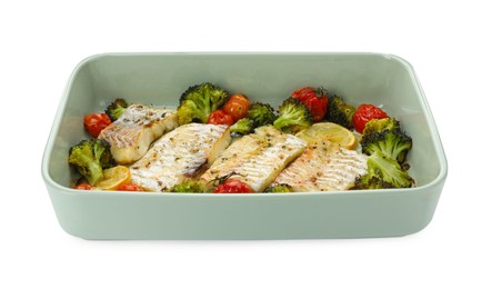 Pieces of delicious baked cod with vegetables, lemon and spices in dish isolated on white