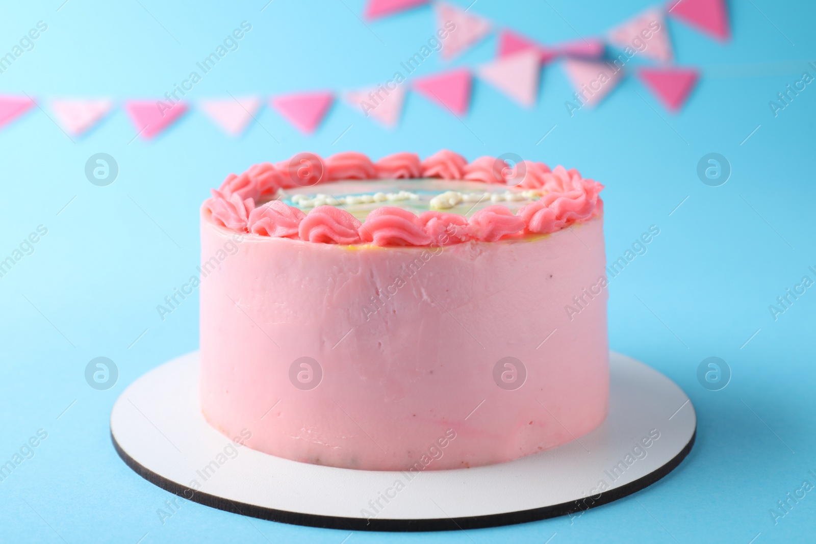 Photo of Cute bento cake with tasty cream on light blue background