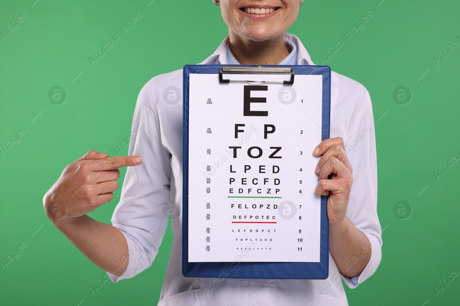 Photo of Ophthalmologist pointing at vision test chart on green background, closeup