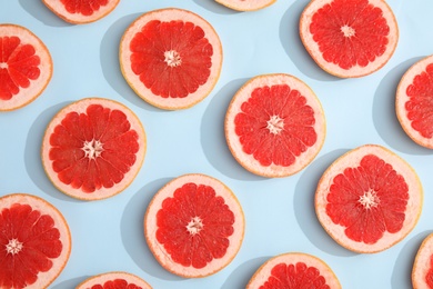 Photo of Fresh sliced ripe grapefruit on color background, flat lay