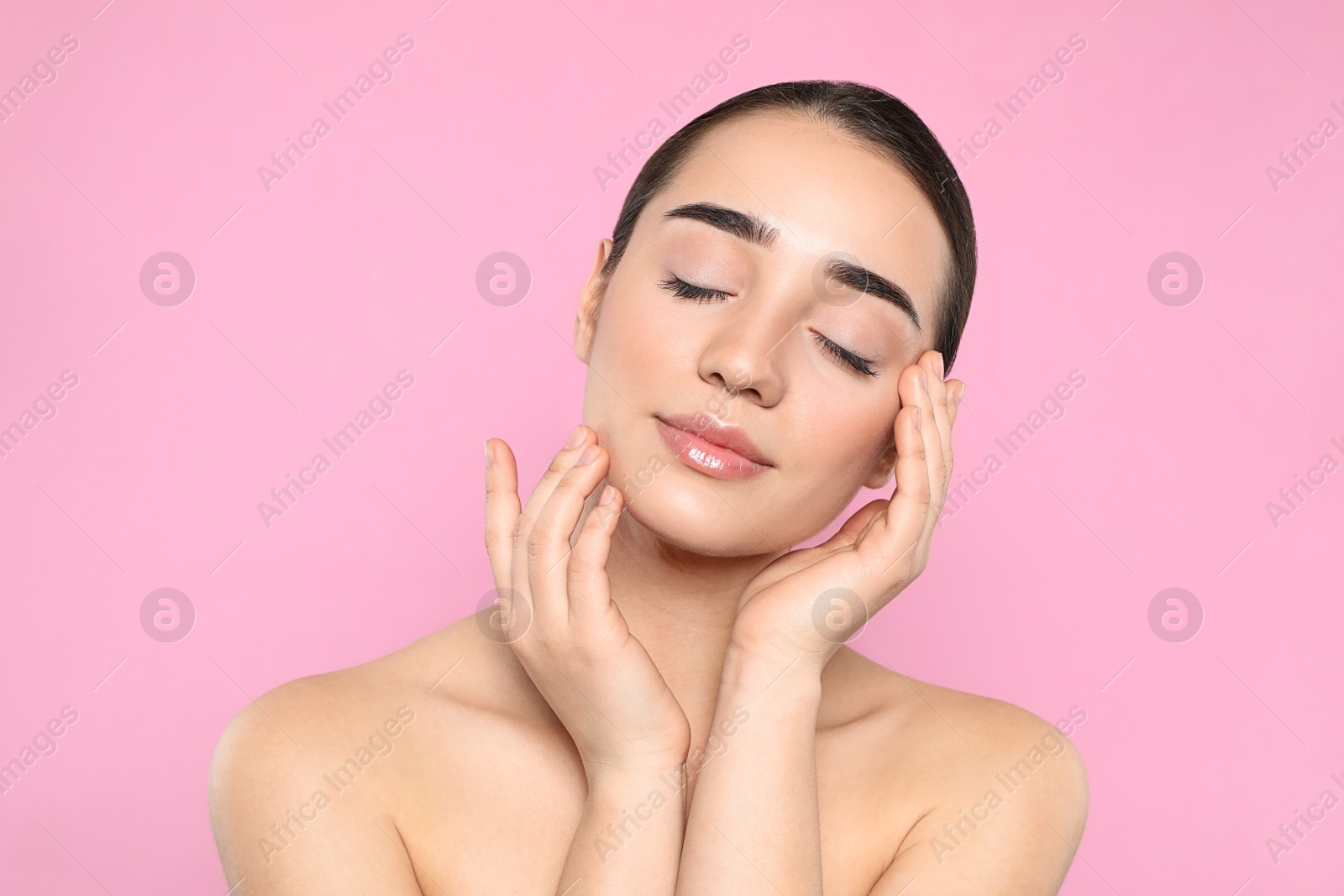 Photo of Portrait of young woman with beautiful face against color background