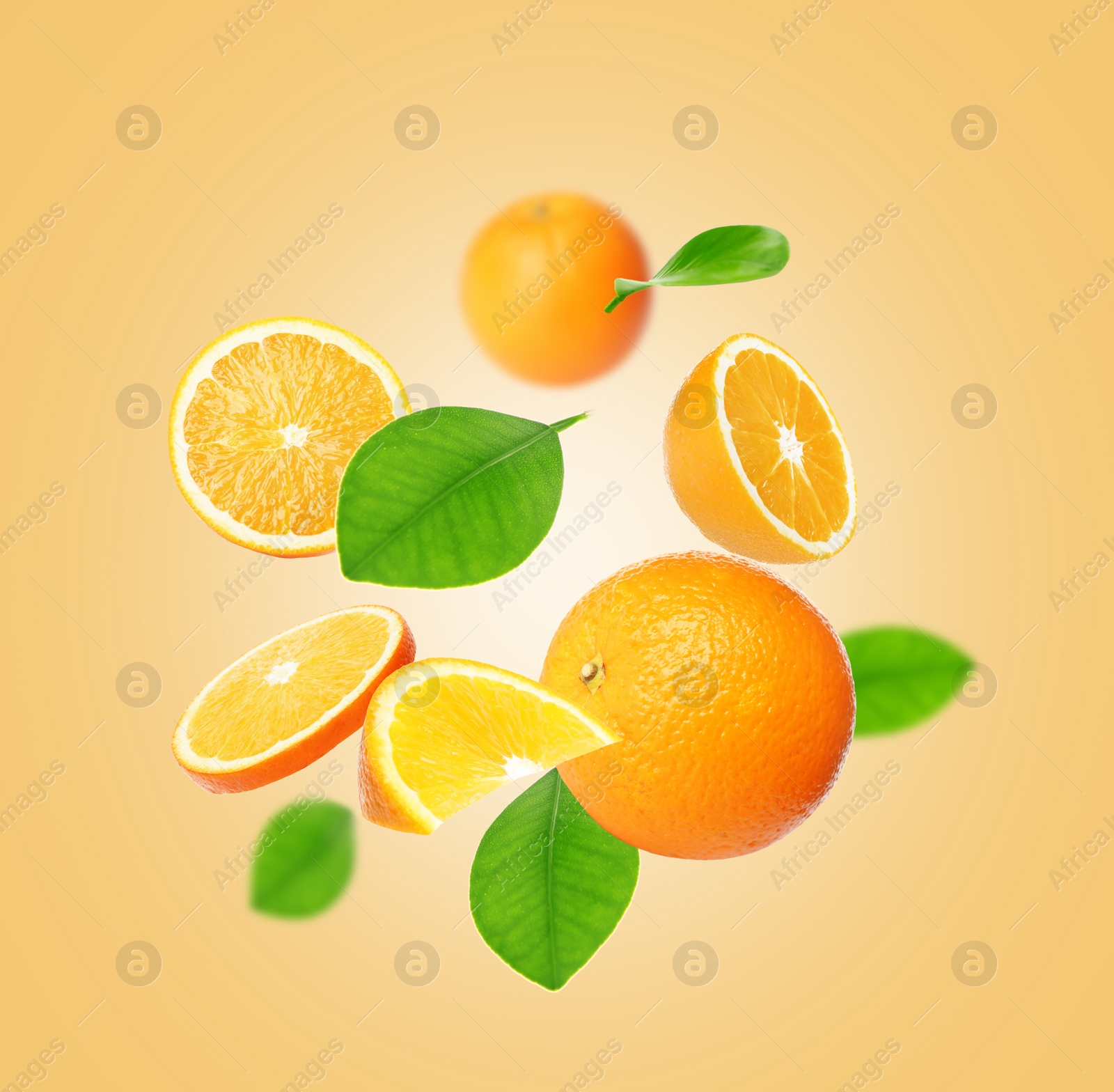 Image of Cut and whole oranges with green leaves flying on pale orange background