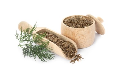 Photo of Wooden jar of dry seeds, scoop and fresh dill isolated on white