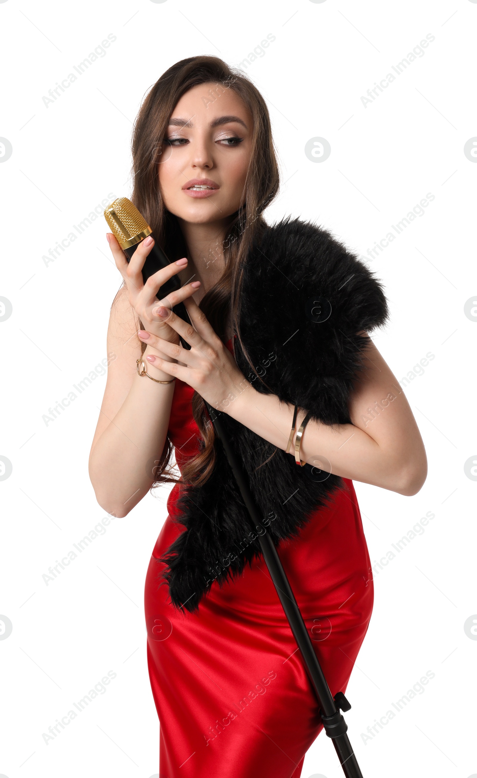 Photo of Beautiful young woman in stylish red dress with microphone singing on white background