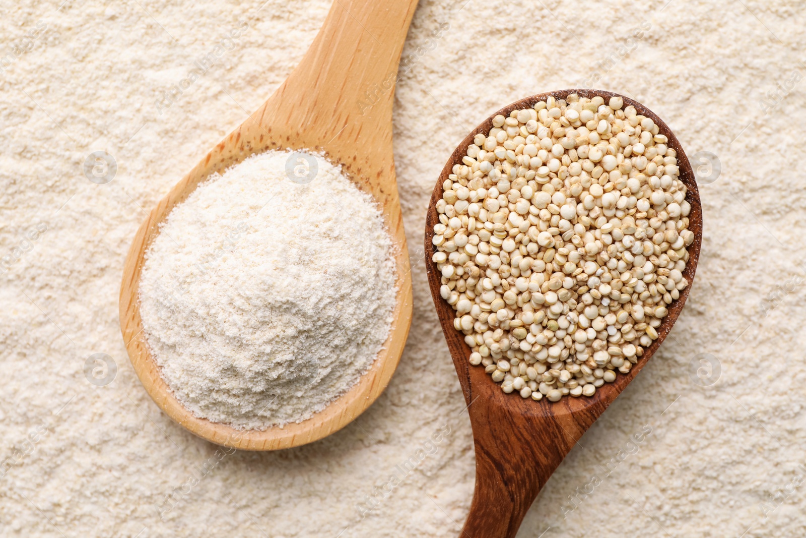 Photo of Wooden spoons with quinoa flour and seeds, top view