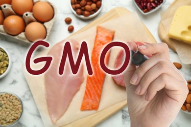 Image of GMO concept. Closeup view of woman with different fresh products on table