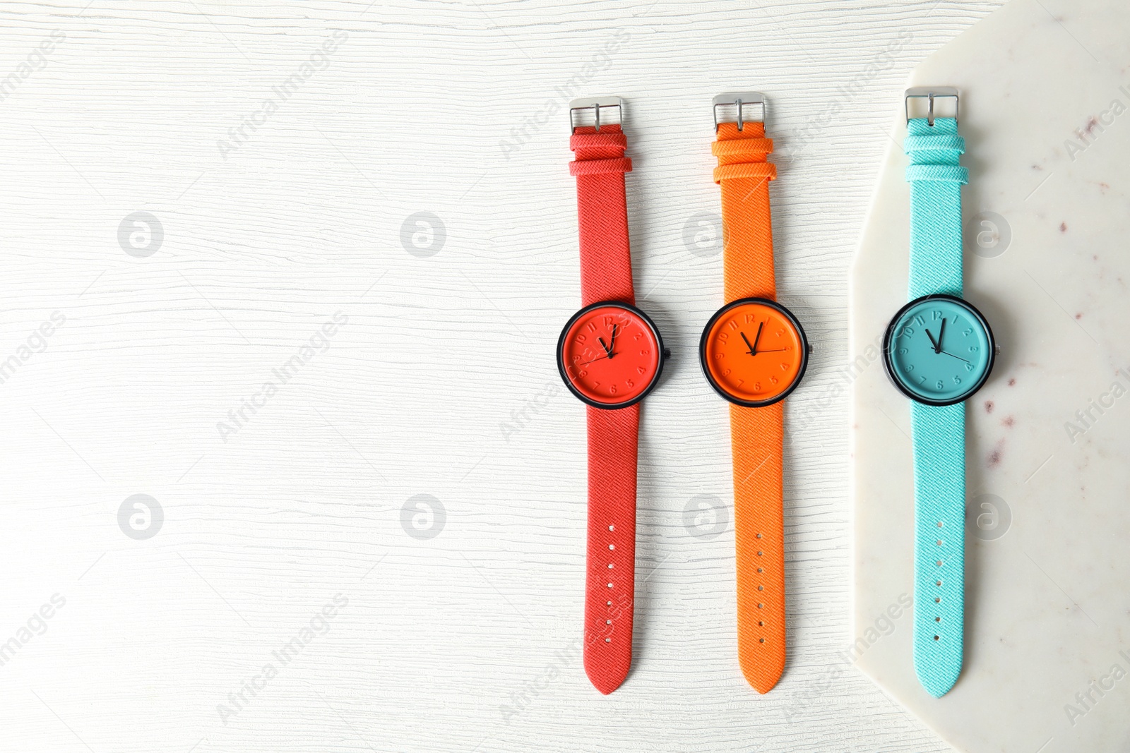 Photo of Flat lay composition with stylish wrist watches and space for text on wooden background. Fashion accessory