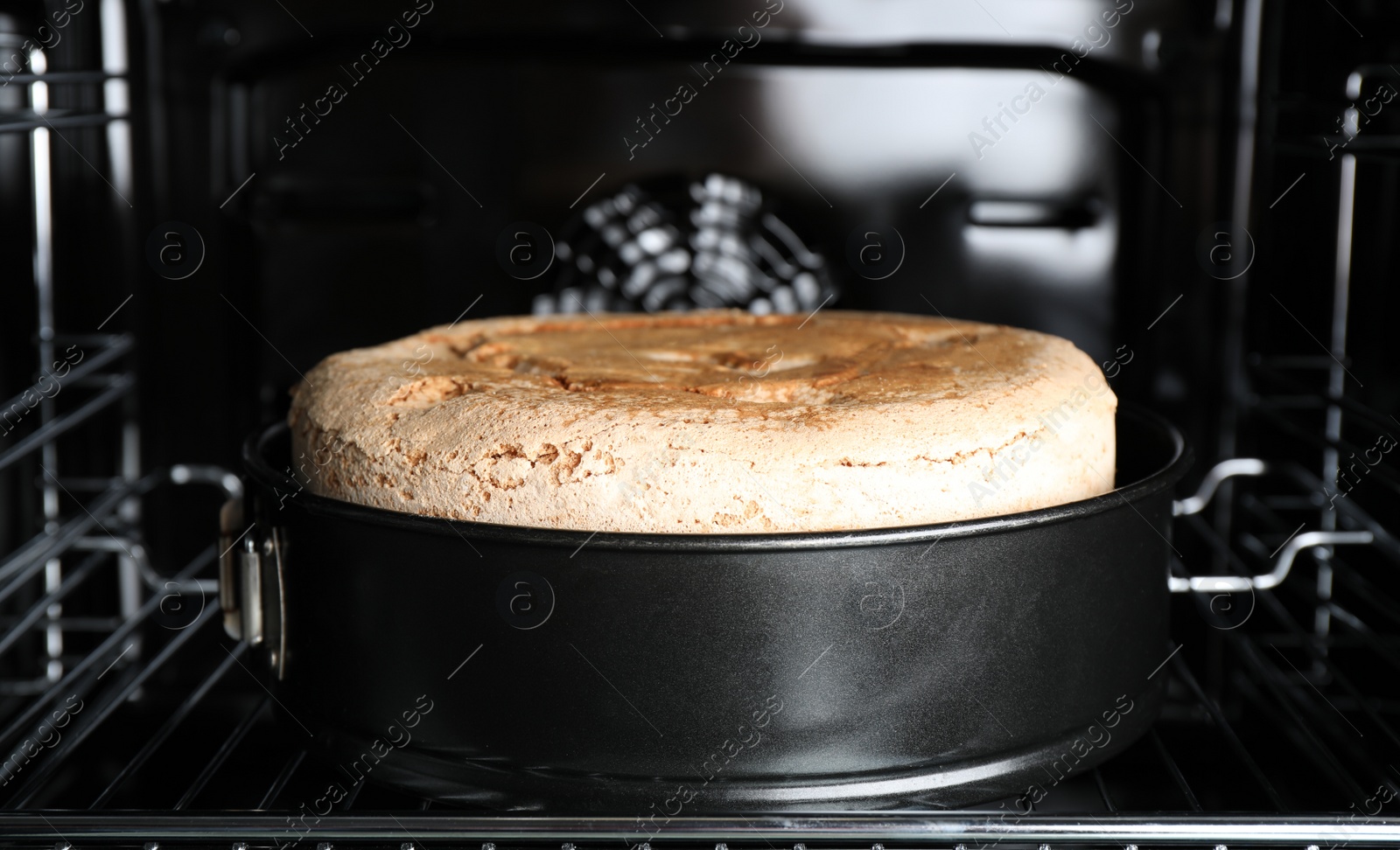 Photo of Delicious fresh homemade cake on rack in oven