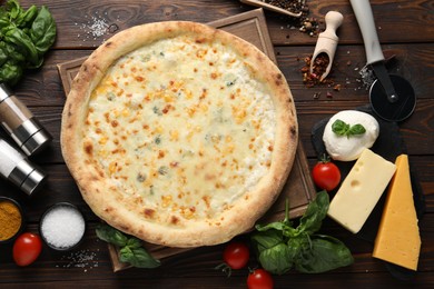 Flat lay composition with delicious cheese pizza and ingredients on wooden table