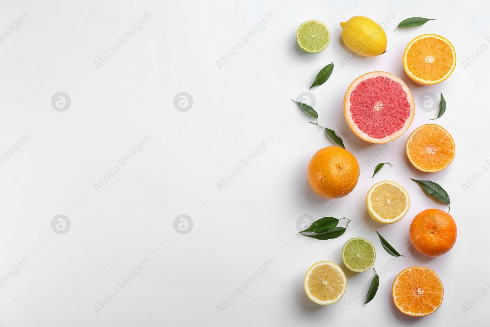 Photo of Flat lay composition with tangerines and different citrus fruits on white background. Space for text