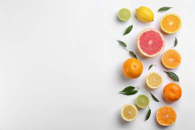 Photo of Flat lay composition with tangerines and different citrus fruits on white background. Space for text