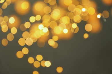 Photo of Blurred view of gold lights on dark background. Bokeh effect