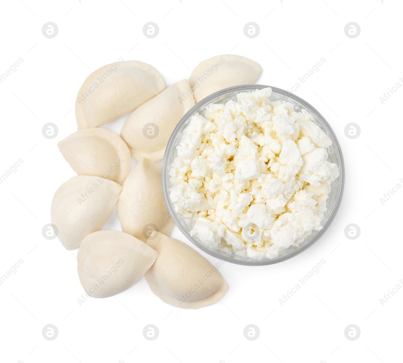 Photo of Raw dumplings (varenyky) and bowl with cottage cheese on white background, top view