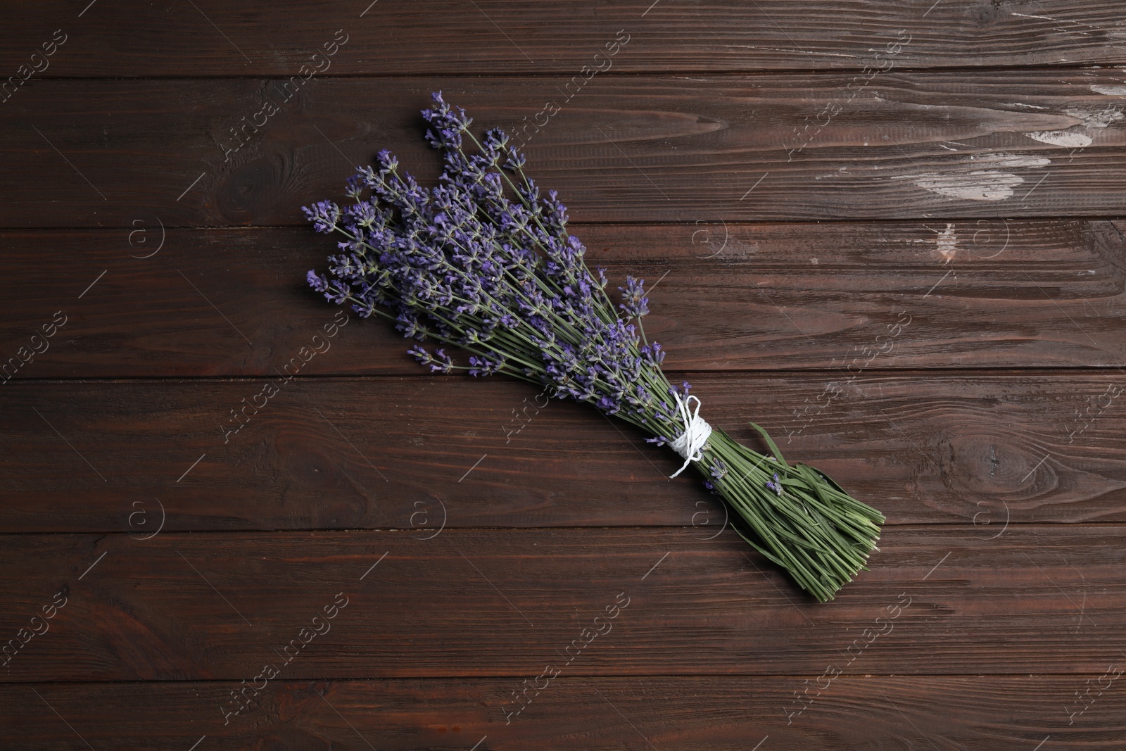 Photo of Beautiful lavender bouquet on wooden background, top view