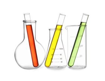 Image of Glass flasks, beaker and test tubes with colorful liquids isolated on white