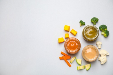 Healthy baby food and ingredients on white background, top view