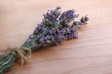Photo of Bouquet of beautiful lavender flowers on wooden table, closeup