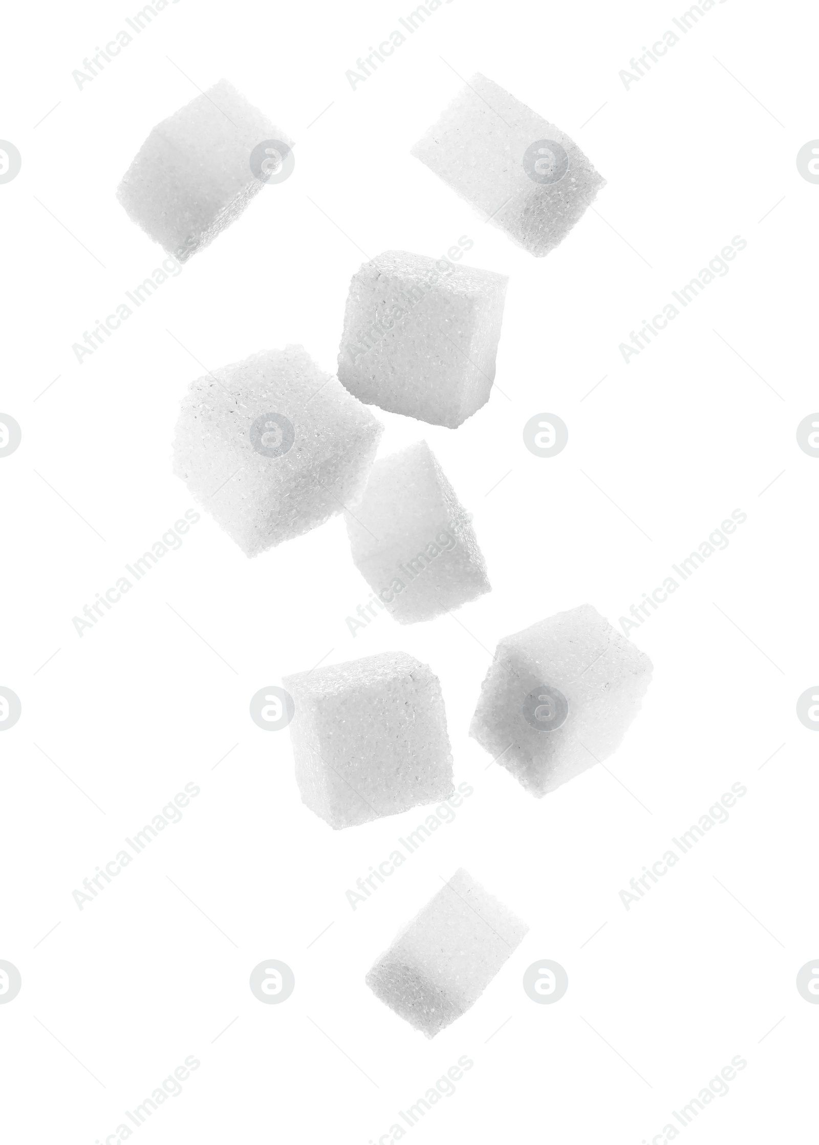 Image of Refined sugar cubes in air on white background