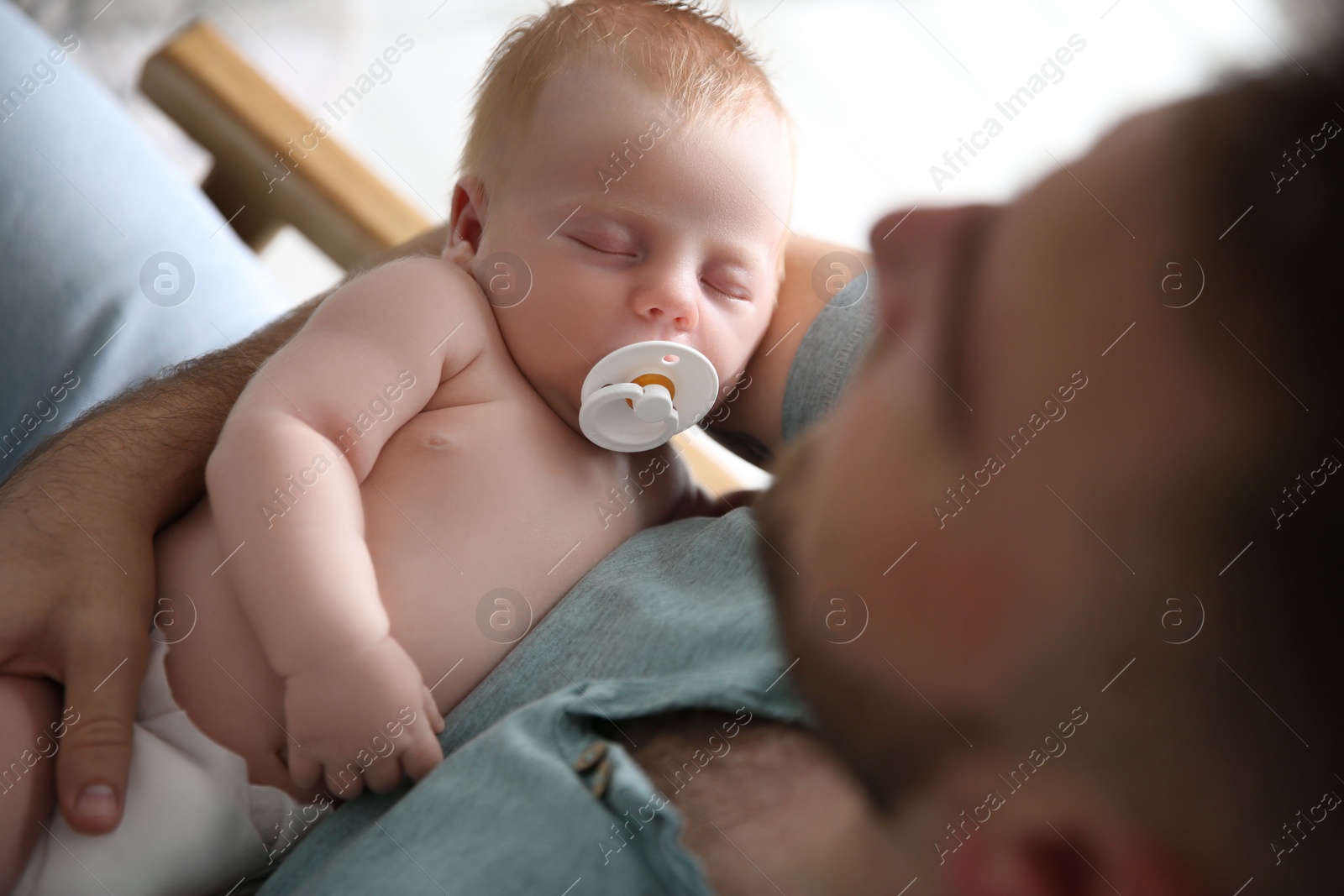 Photo of Father with his newborn son, above view