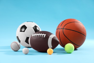 Photo of Many different sports balls on light blue background