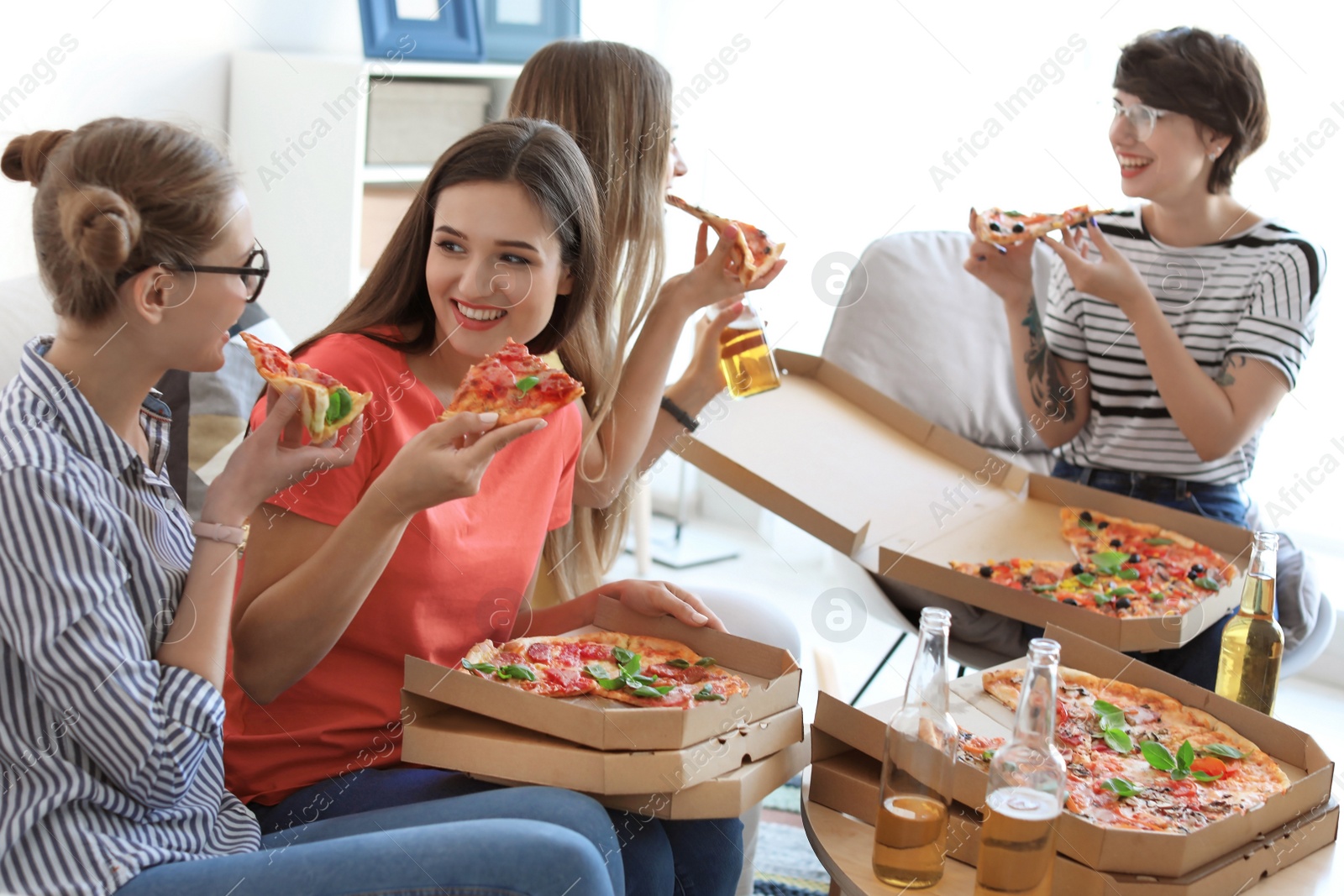 Photo of Young people having fun party with delicious pizza indoors