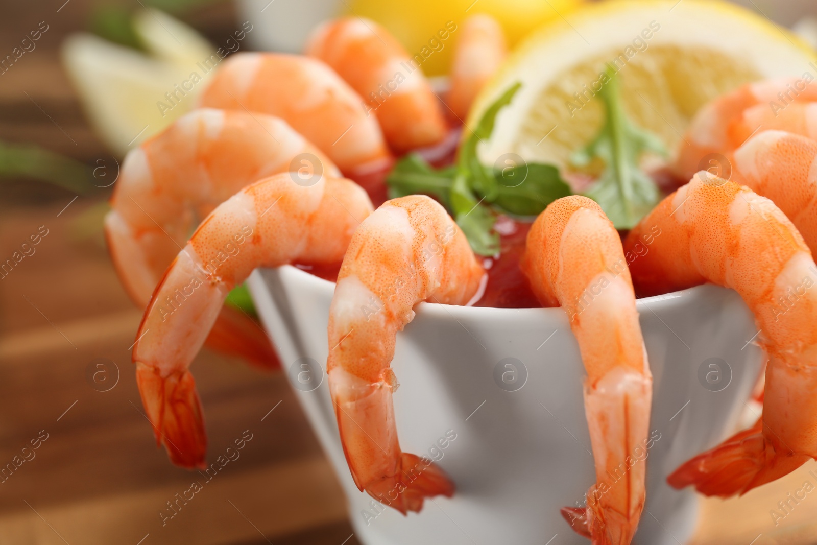 Photo of Delicious shrimp cocktail with tomato sauce, closeup