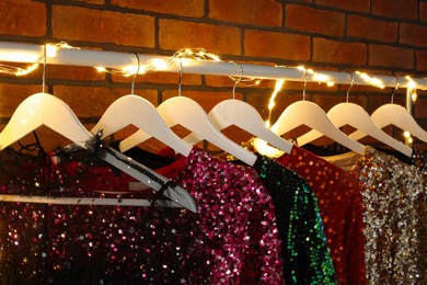 Photo of Collection of different beautiful women's party dresses in showroom. Stylish trendy clothes for high school prom