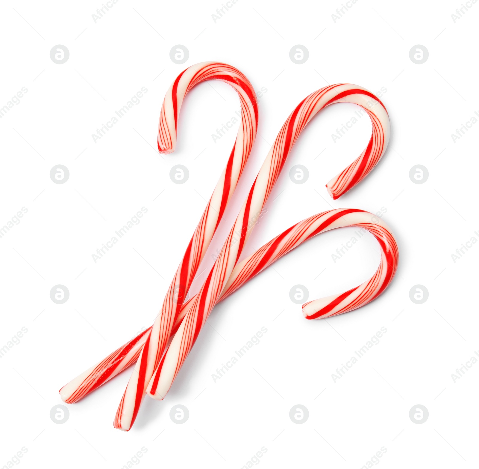 Photo of Tasty candy canes on white background. Festive treat