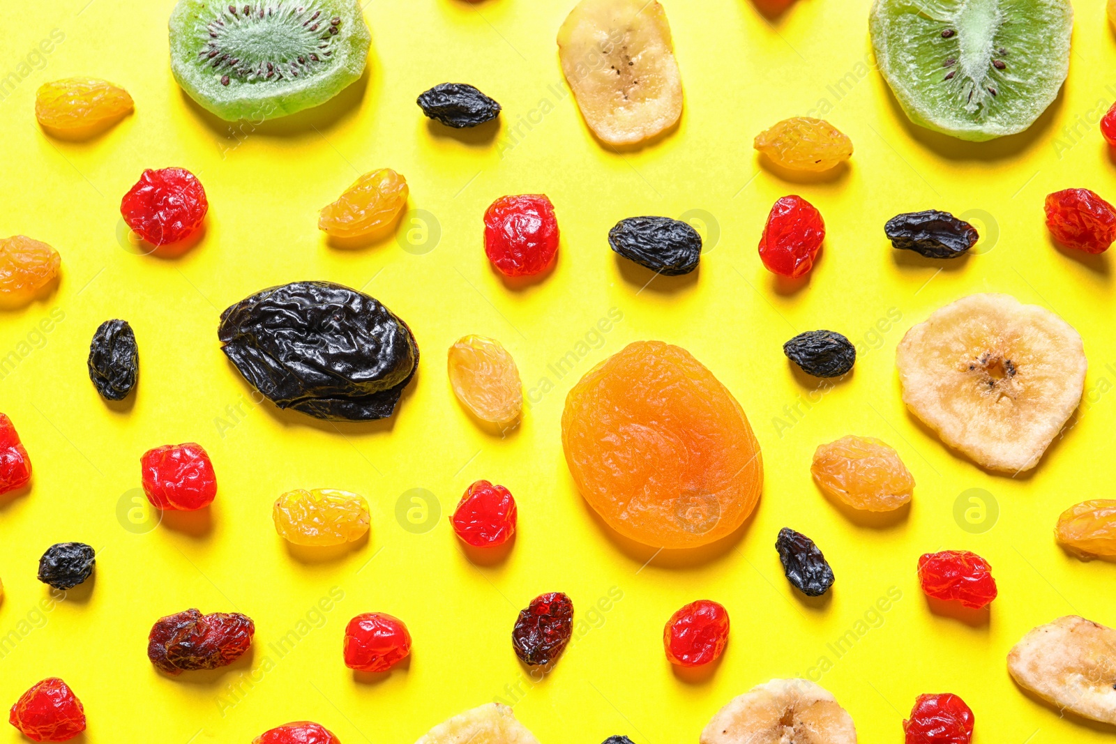 Photo of Flat lay composition with different dried fruits on color background. Healthy lifestyle