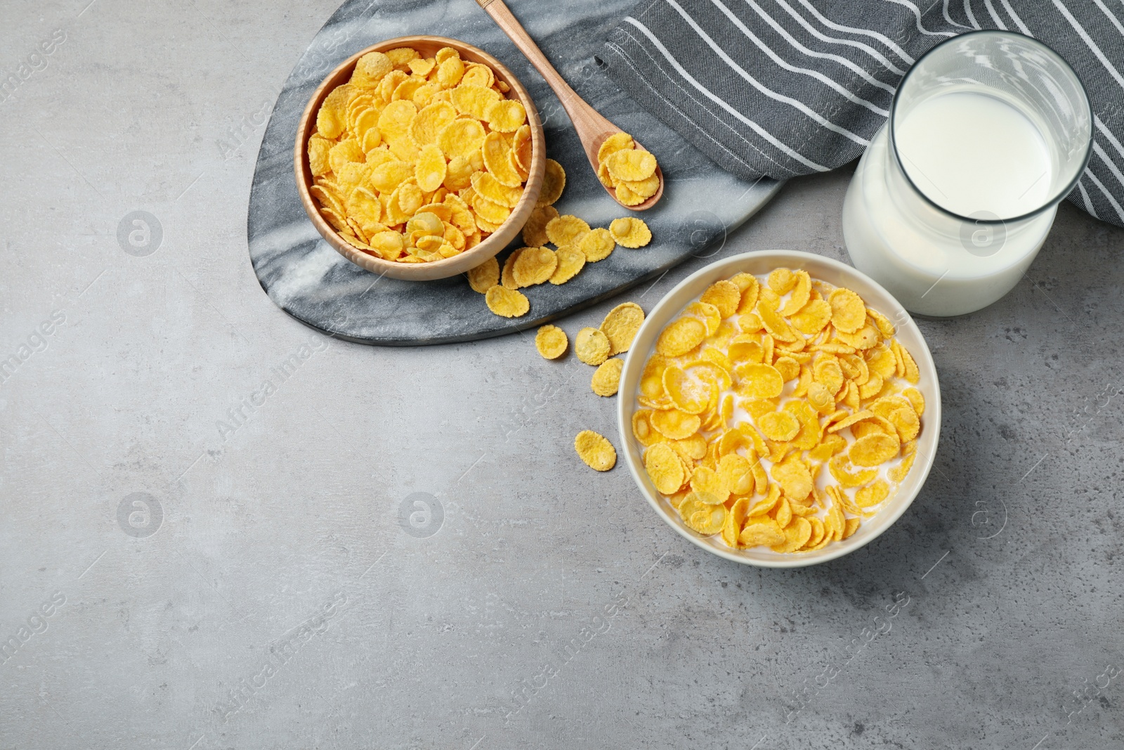 Photo of Flat lay composition with tasty corn flakes on light grey table