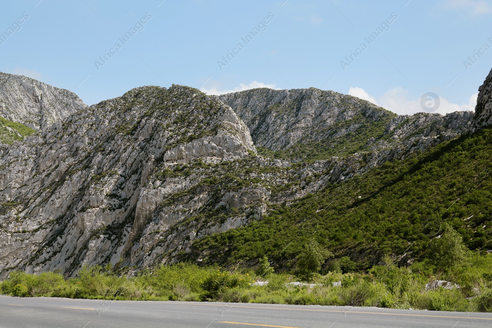 Photo of Picturesque view of beautiful mountains and road under cloudy sky