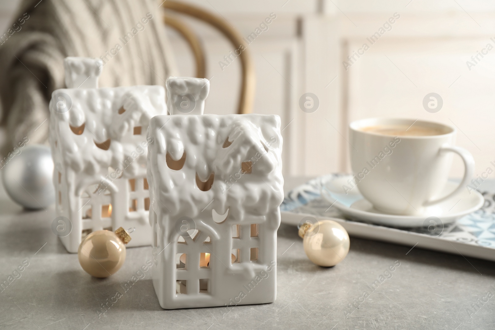 Photo of Composition with house shaped candle holders on light table. Christmas decoration