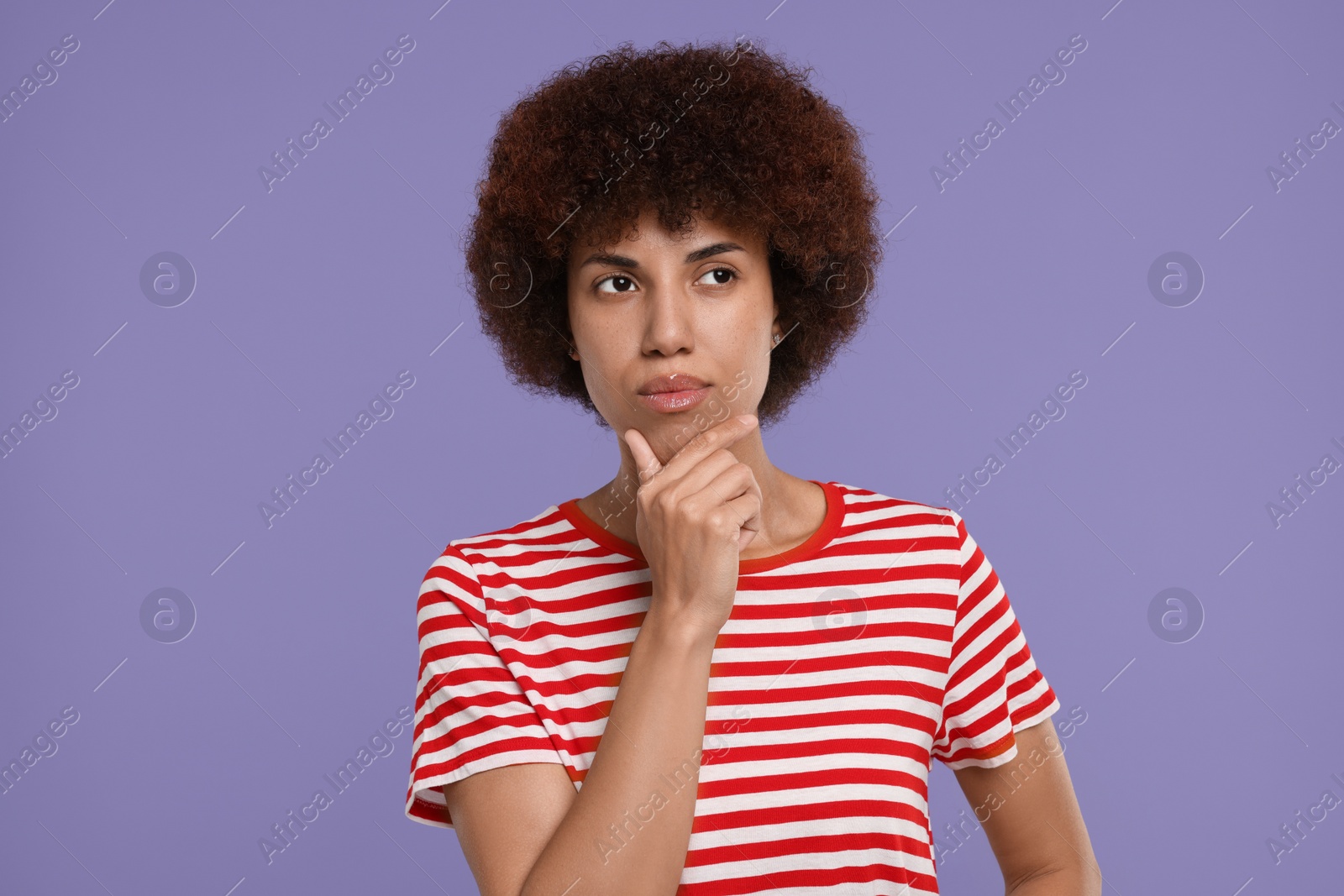 Photo of Portrait of thoughtful young woman on purple background