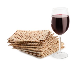Photo of Traditional matzos and red wine on white background