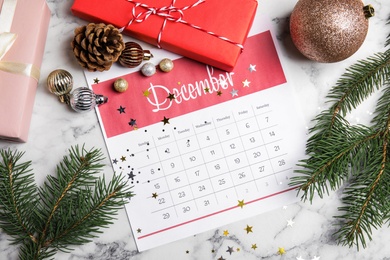 Photo of Flat lay composition with paper calendar on white marble table