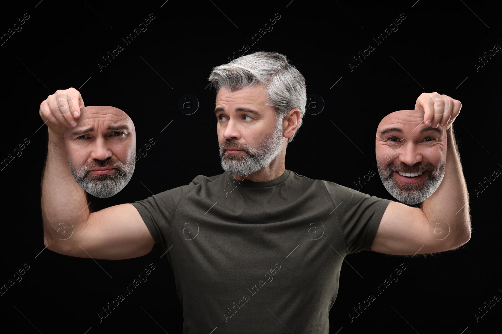 Image of Mature man holding masks with his face showing different emotions on black background. Balanced personality