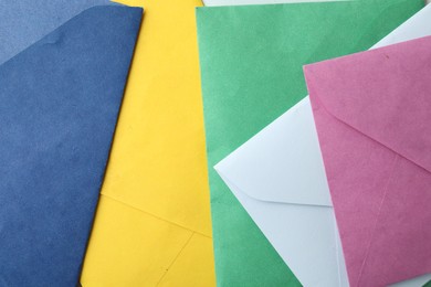 Photo of Colorful paper envelopes as background, top view