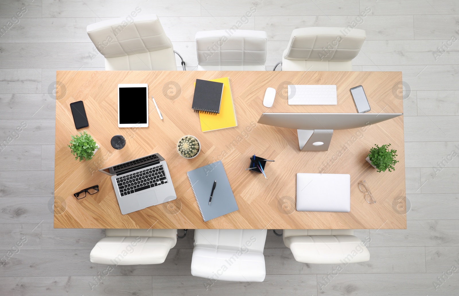 Photo of Modern office table with devices and chairs, top view