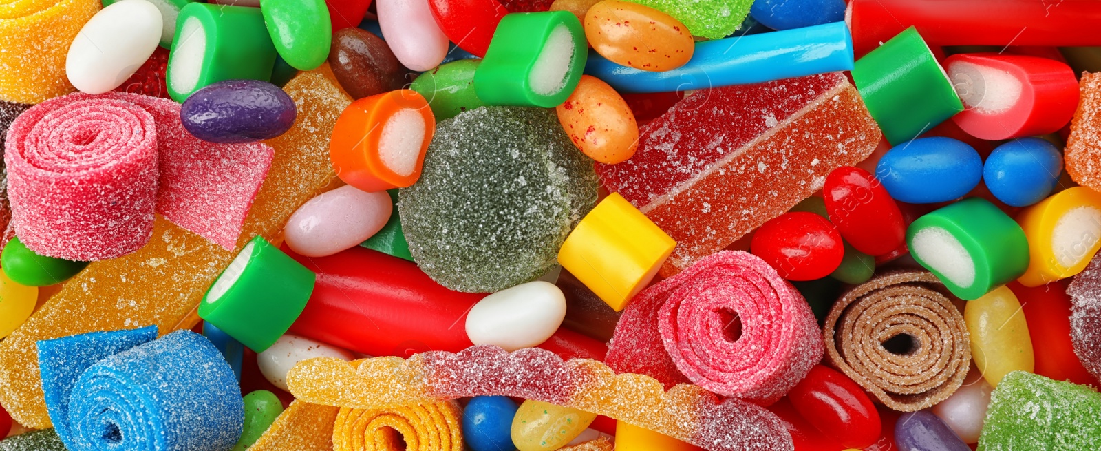 Image of Delicious colorful chewing candies as background, top view. Banner design 