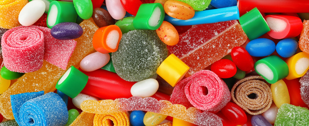 Image of Delicious colorful chewing candies as background, top view. Banner design 