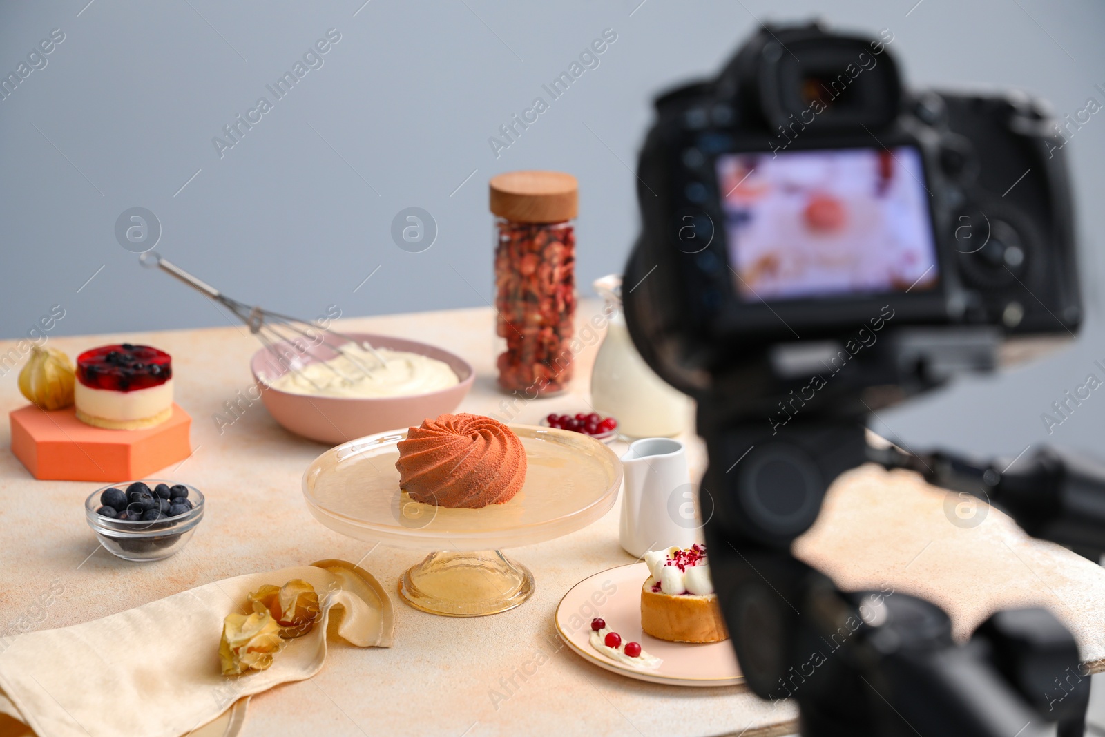 Photo of Professional equipment and composition with delicious dessert on beige table in studio. Food photography