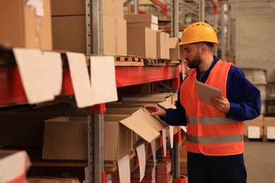 Man with tablet working at warehouse. Logistics center