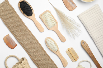 Composition with hair combs and brushes on white background, top view